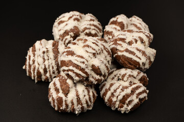 Profiteroles with coconut cream on a black background.