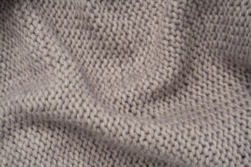 Grey wool sweater texture as a background.