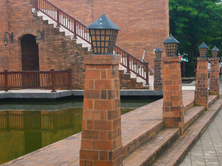 A row of ethnic garden lights with red brick supports © Dwi
