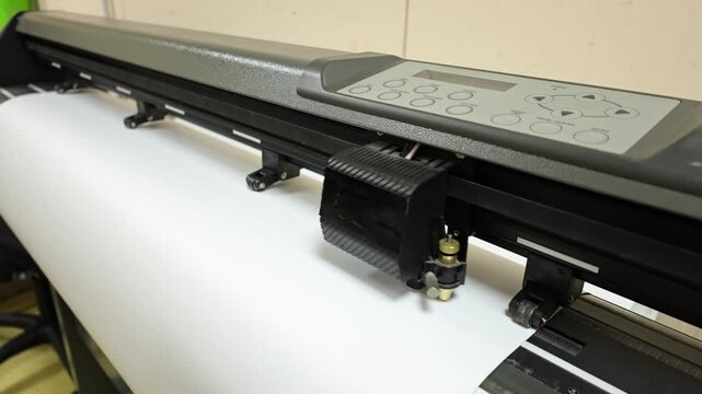 Cutting plotter close-up. The process of cutting a vinyl film.