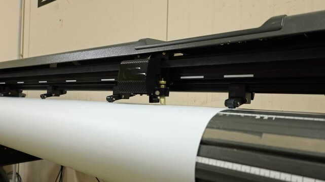 Cutting plotter close-up. The process of cutting a vinyl film.