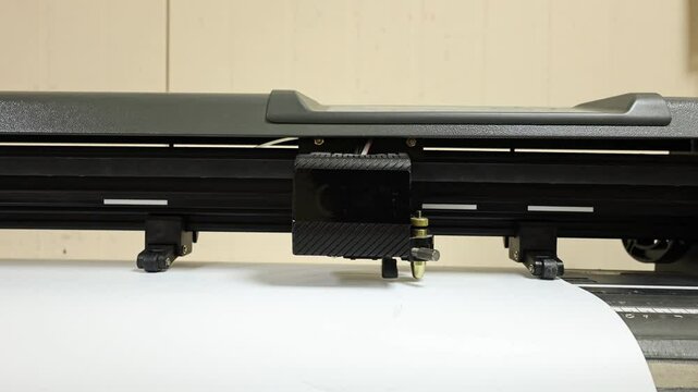 Cutting plotter close-up. The process of cutting a vinyl film.