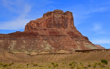 the colorful red rock  butte of  assembly hall peak  on a sunny summer day  along the buckhorn draw scenic backway in the northern san rafael swell near green river,  utah 