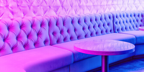 Obraz premium VIP zone in the empty interior of a nightclub. Soft sofa and table in neon glow, elite nightclub