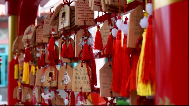 Slow Motion of Japanese Ema Boards With Colorful Tassels Hanging in a Temple Setting at Pantjoran PIK, Jakarta - Indonesia
