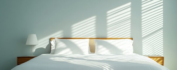A bright and airy bedroom with soft light casting parallel shadows on the neatly made bed and walls