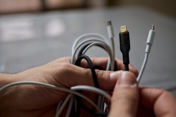 Tangled Cords in Hand The Everyday Clutter and Chaos of Our Modern Technology Life