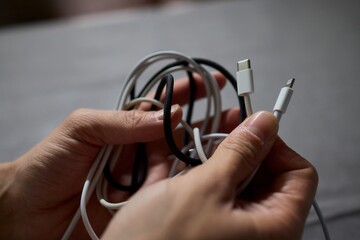 Tangled Cords in Hand The Everyday Clutter and Chaos of Our Modern Technology Life