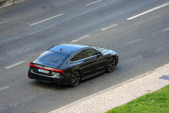Modern luxury car driving on asphalt road