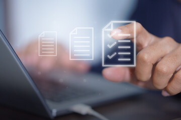 Finger pointing at holographic checklist icons on a screen, emphasizing organization, digital tools, and innovation