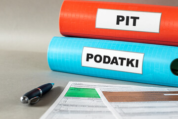 Taxes Poland. PIT (personal individual tax) tax settlement for individuals in Poland. Financial concept. Binders with Polish words. PODATKI (Podatki) and PIT (Personal individual tax)