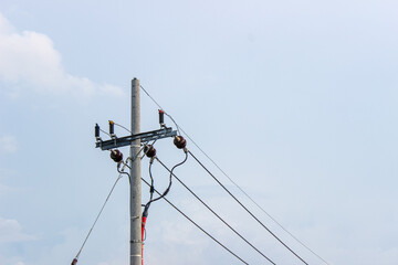 Power pole and electric wires stretching across the sky