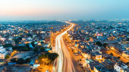 Fototapeta premium Aerial view of a vibrant cityscape with illuminated roads during sunset