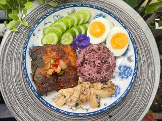 Steamed curry fish, baked garlic chicken, boiled egg and berry rice.