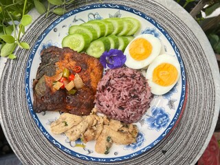 Steamed curry fish, baked garlic chicken, boiled egg and berry rice.