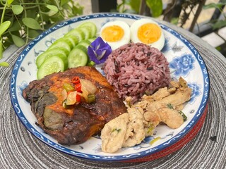 Steamed curry fish, baked garlic chicken, boiled egg and berry rice.