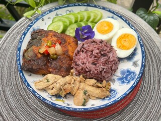 Steamed curry fish, baked garlic chicken, boiled egg and berry rice.