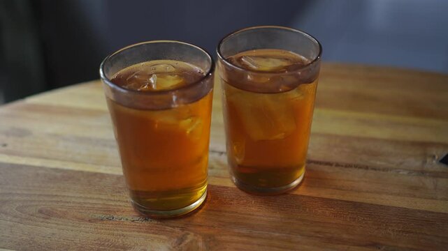 Two glasses of Ocha tea are served on the restaurant table and ready to drink.