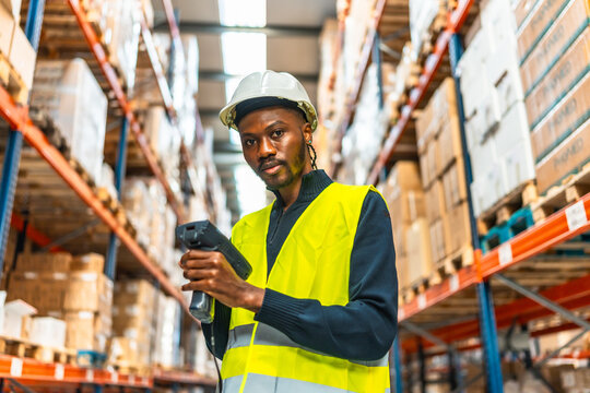 African worker scanning packages in a warehouse