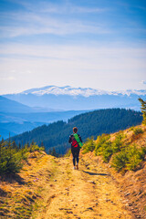 Fototapeta premium woman during a tourist trip to the mountains. a woman in the mountains 