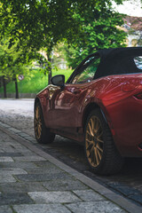 a red sports car is parked on the street
