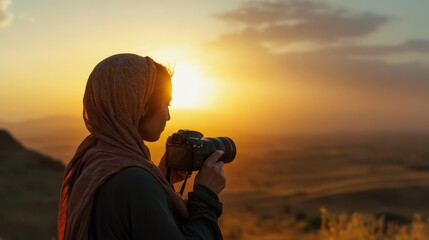 Fototapeta premium A serene photo of a photographer adjusting the focus on a DSLR camera while capturing a sunset landscape