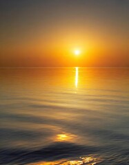 Fototapeta premium Gentle waves reflecting the golden hues of a breathtaking sunrise over a tranquil ocean.