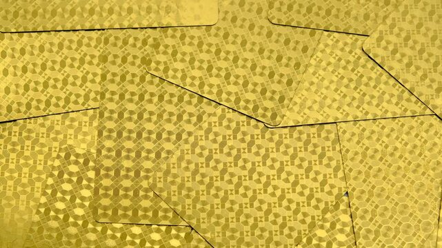 golden playing cards background, back view