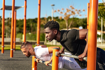 Obraz premium Calisthenics Athletes Exercising in Public Park