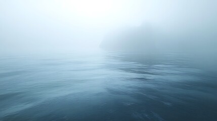 Obraz premium Misty sea with indistinct landmass.