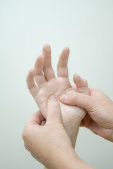 Close-up of female hands during massage. Vertical photo. 