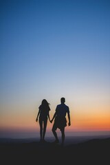 Couple holding hands on a sunset