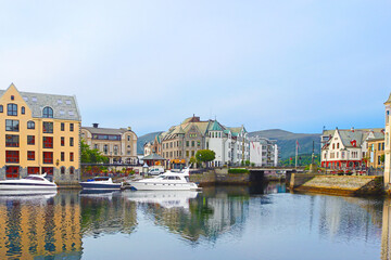 Alesund city on a summer day, Norway. View of colorful Art Nouveau architecture port