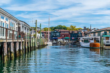 Obraz premium A view from a boat along moorings towards Bowens Wharf at Newport, USA in the fall
