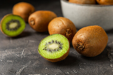 Kiwi on wooden background. Whole fruit and slices pieces of green kiwi on table. fresh ripe juicy...