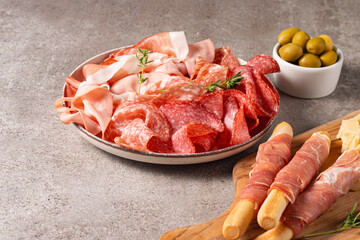 Charcuterie board. Antipasti appetizers of meat platter with salami, prosciutto crudo or jamon and olives.