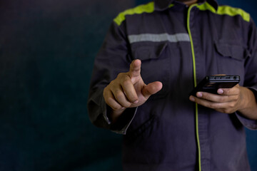 This image captures a repairman’s hand operating a phone, showcasing precise use of technology. It reflects professionalism, technical expertise, and adherence to safety standards in modern workflows.