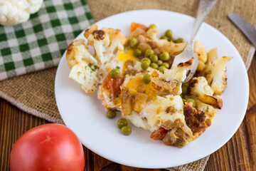 fried omelette with cauliflower and vegetables in a plate