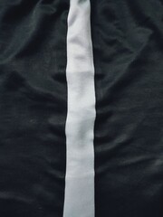 The texture and background of the fabric is black with white lines