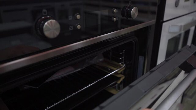 Black oven with metallic knobs