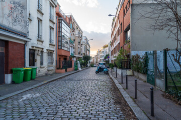 Quiet cobblestone street in a residential neighborhood at sunset