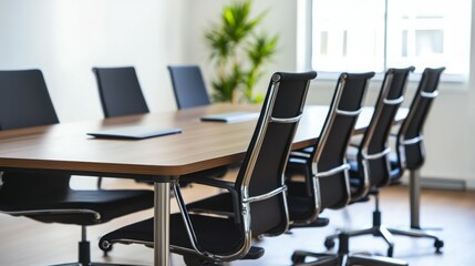A modern conference room with a large table and ergonomic chairs, designed for meetings.