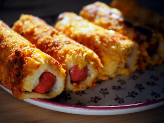 Crispy Hot Dog Rolls with Melted Cheese and Golden Bread Crumbs, Perfect Snack or Party Food Idea