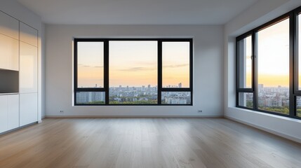 Fototapeta premium A modern, empty room with large windows showcasing a sunset view over the city skyline, highlighting contemporary architecture and design.
