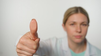 Woman medical doctor in uniform touches glass screen panel, thumb finger print on transparent...