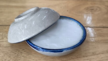 Thai dessert (khanom thuay) coconut milk custard in small porcelain cup .