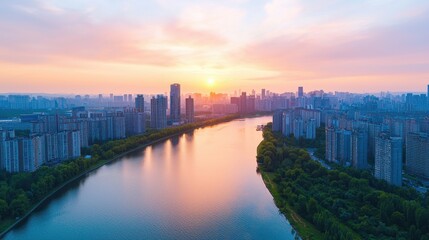 Fototapeta premium A stunning aerial view of a cityscape at sunset, showcasing buildings along a reflective river, enveloped in warm, vibrant colors.