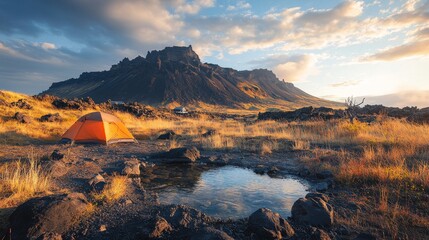 Fototapeta premium Camping near a volcanic mountain under a colorful sky during sunset