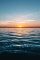 Fototapeta premium serene ocean sunset with calm water and a clear sky, vibrant orange and blue gradient, peaceful horizon, nature inspiration, relaxation concept, tranquility theme, minimalist seascape 