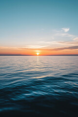 Obraz premium serene ocean sunset with calm water and a clear sky, vibrant orange and blue gradient, peaceful horizon, nature inspiration, relaxation concept, tranquility theme, minimalist seascape 